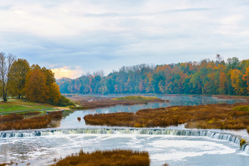 View of the Rumba waterfall in autumn in the city of Kuldiga in Latvia.