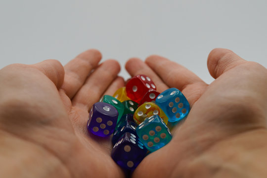 Woman's hands holding a lot of colorful cubes and shaking them on white background. Square cubes on woman's hands. Abstract cube blocks and logic thinking concept - Powered by Adobe