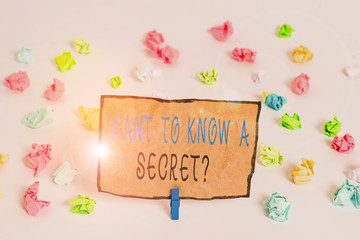 Text sign showing Want To Know A Secret Question. Business photo text to divulge a confidential vital information Colored crumpled papers empty reminder white floor background clothespin