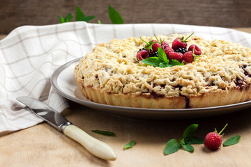 Berry shortcrust pie with crumble on a plate