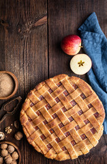Homemade dessert, old fashioned lattice crust pie with grated apple and walnut filling, sprinkled with granulated sugar and cinnamon, with copy space