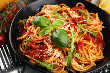 Plate of delicious spaghetti Bolognaise or Bolognese with savory minced beef and tomato sauce garnished with parmesan
