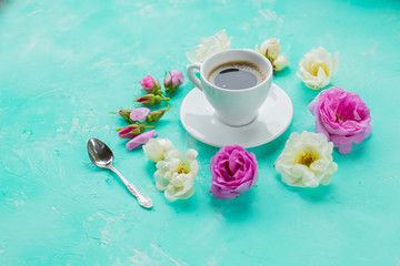 Flat lay composition with buds flowers and cup of coffee on color background. Copy Space.Valentine's day, birthday, mother or wedding greeting card.cozy and romantic breakfast