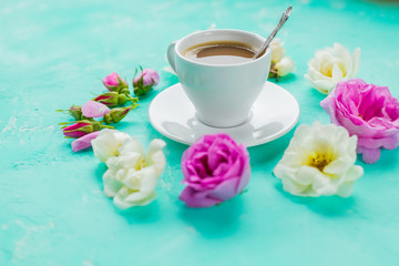 Fototapeta na wymiar Flat lay composition with buds flowers and cup of coffee on color background. Copy Space.Valentine's day, birthday, mother or wedding greeting card.cozy and romantic breakfast