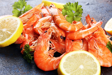 Raw fresh Prawns Langostino Austral. shrimp seafood with lemon and spices on dark