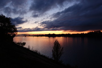 Sunset over river with bridge at Dubna in Russia in autumn