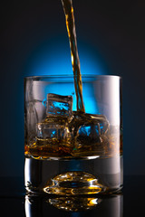 glass of whiskey with ice cubes