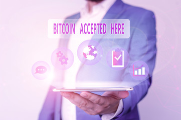 Conceptual hand writing showing Bitcoin Accepted Here. Concept meaning you can purchase things through Cryptocurrencies Male human wear formal suit presenting using smart device