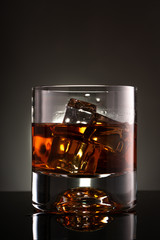 glass of whiskey with ice cubes