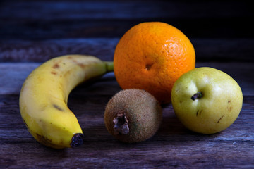 Fruits for salad on a wooden table.