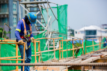 Builder worker in safety protective equipment. Professional industrial climber in helmet and...