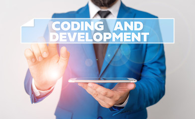 Handwriting text Coding And Development. Conceptual photo Programming Building simple assembly Programs Businessman with pointing finger in front of him