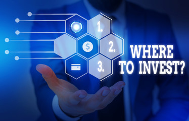 Writing note showing Where To Invest Question. Business concept for asking someone about place to put money into Male wear formal suit presenting presentation smart device