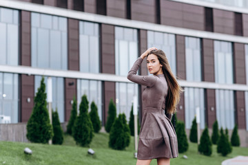 A young girl walks near the office with a handbag on her shoulder