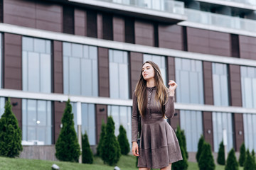 A young girl walks near the office with a handbag on her shoulder