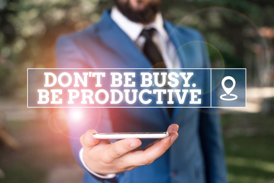 Handwriting text writing Don T Be Busy Be Productive. Conceptual photo Work efficiently Organize your schedule time Businessman in blue suite stands with mobile phone in hands