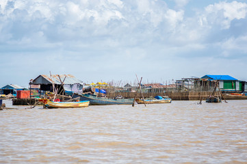 Fototapeta na wymiar Siem Reap / Cambodia - May 26 / 2019 : view of floating village under clouds at a sunny day