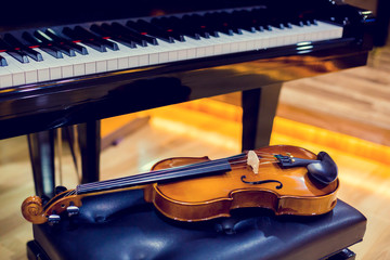 Violin and piano on wooden background. Musical instrument for learning music in music room. The music learning concept.
