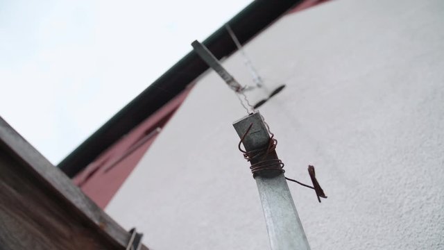 Lightning rod connected with cooper wire 4K. Low angle close-up of lightning rod in focus wired together with thin cooper wire.