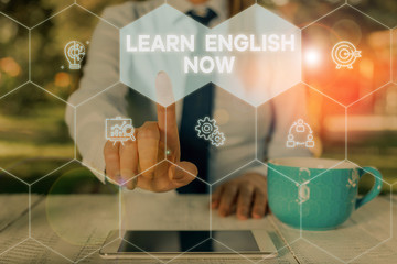 Word writing text Learn English Now. Business photo showcasing gain or acquire knowledge and skill of english language Woman wear formal work suit presenting presentation using smart device