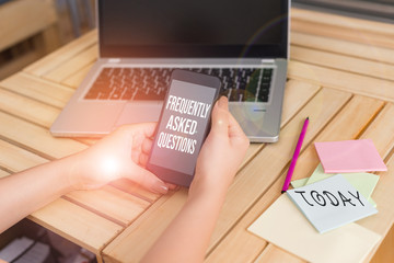 Text sign showing Frequently Asked Questions. Business photo showcasing inquries that been informed more than one time woman laptop computer smartphone office supplies technological devices
