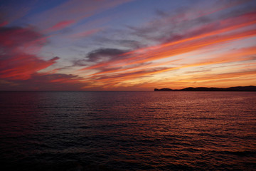 Fototapeta premium Sunset in Alghero, Sardinia, Italy. Capo Cassia in the background.