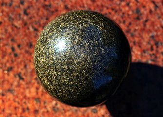 Granite stone polished ball on a granite slab