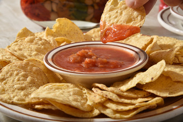 Dipping a tortilla chip in salsa