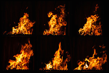 Bright fire flame on a dark background. Fire burning at night. A fire in the grill, fireplace and hearth.