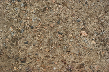 Yellow cobblestone gravel stones boulders pebbles texture background close-up.