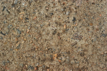 Yellow cobblestone gravel stones boulders pebbles texture background close-up.