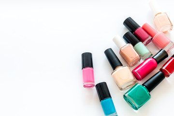 Choose nail polish. Polish bottels on white background top view copy space