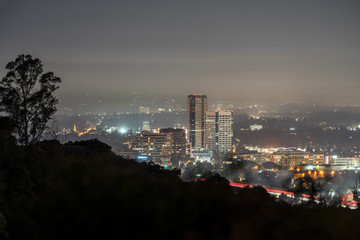 Foggy morning twilight view of the Burbank media district in the San Fernando Valley area of Los Angeles, California.  Shot from hilltop in popular Griffith Park.  