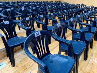 Gestuhlt, Blaue nummerierte Stühle als Sitzplatz für Veranstaltung, Theater oder Kino