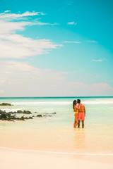 Fototapeta na wymiar Couple in beach holiday romance. Tourist on Tropical beach with turquoise ocean waves and white sand. Sand bay view. Holiday, vacation, paradise, summer vibes. Isabela, San Cristobal