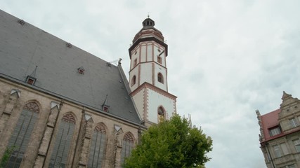 St. Thomas Church (Thomaskirche) in Leipzig, Germany, Europe. Remains of Johann Sebastian Bach are here. 4K Background Panning Low Angle Shot