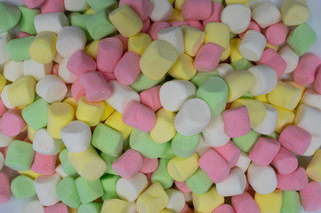 A pile of colorful sweet marshmallow candies.