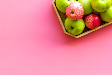 Healthy diet concept. Fresh apples in tray on pink background top view space for text