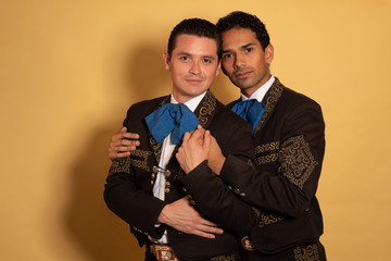 Charro Mexican young gay homosexual couple Mariachi holding in love