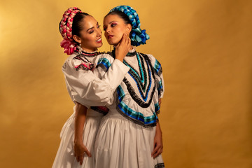 Mexican adelitas Young gay couple lesbian love hug  culture costume typical white