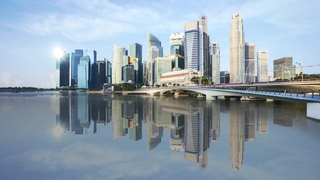 4k time lapse of sunrise at Singapore city skyline with water reflection effect. 