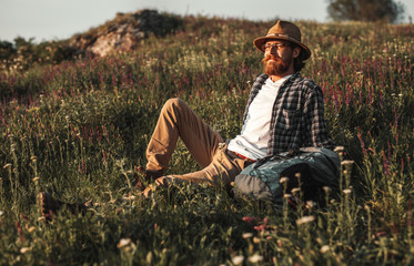 Naklejka na ściany i meble Bearded man resting in countryside
