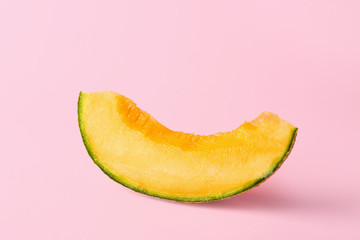 Slice of ripe melon on color background