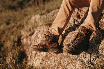 Anonymous traveler resting on rock