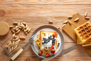 Composition with tasty waffles on table