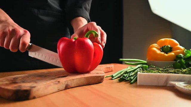 Chef cooking vegetables sweet or bell pepper