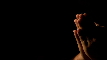 Closeup portrait of a young caucasian man praying