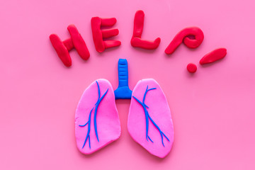 Lung diseases concept. Word help and organ on pink background top view