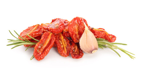 Dried tomatoes and spices on white background