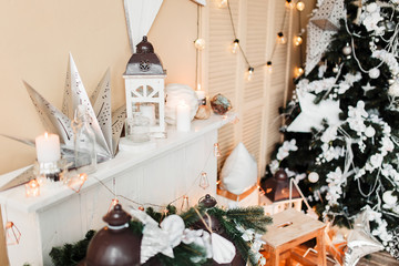 New Year 2020 mood, Christmas tree. Cozy room with fireplace, wardrobe and candlesticks. Merry Christmas.